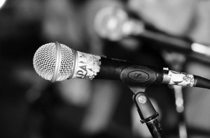 Artistic shot of an SM58 type mic on stage.